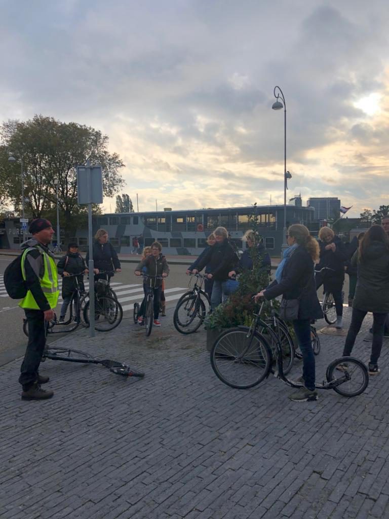 Amsterdam-North on the scooter. Local private guide Lex van Buuren from Lex and the City with the group in front of Café de Pont. October 2019.
