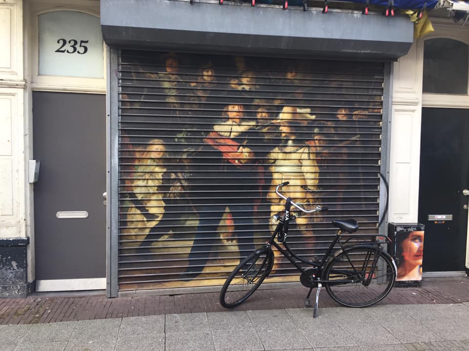 Hidden gem of Amsterdam? Yes :) Rembrandt Nightwatch street art in the hipster quarter “De Pijp” (the pipe) Even this Nightwatch is hidden, as there is a market of front of it.